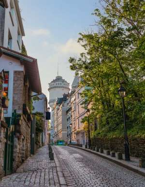 Montmartre Water Tower on a Charming Cobblestone Street in Paris