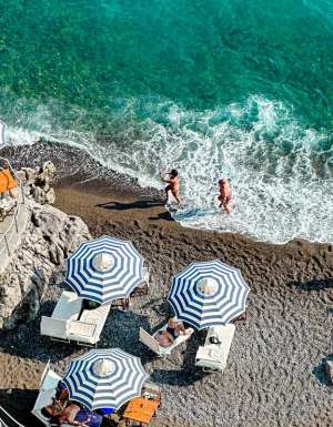 People enjoying the sun and ocean in Positano in Italy