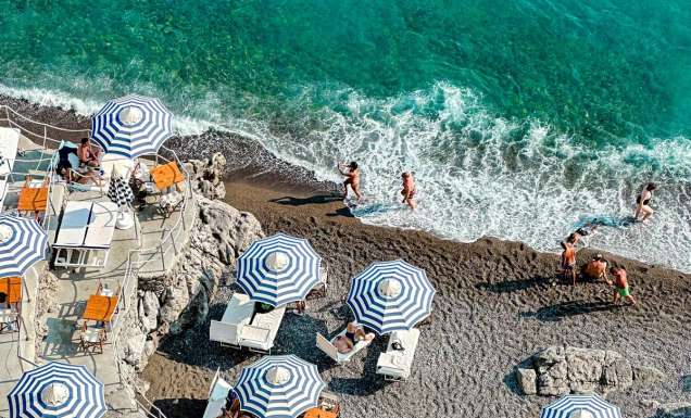 People enjoying the sun and ocean in Positano in Italy