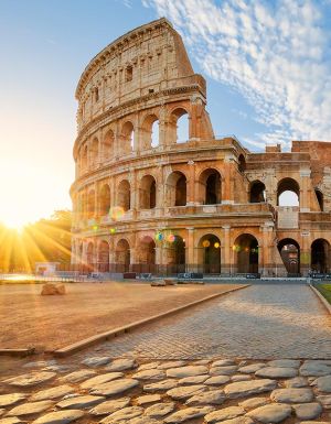 in front of the the Colloseum in rome at sunset