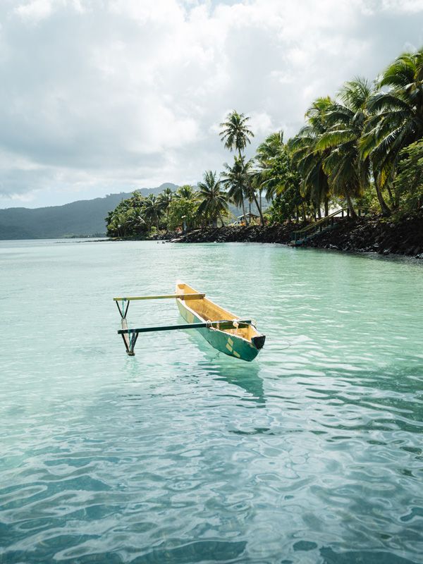 A boat on Savaia’s vivid turquoise lagoon