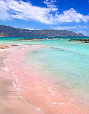 The pink sand at and turquoise water at Elafonissi Beach, Crete, Greece.