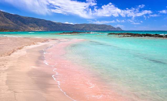 The pink sand at and turquoise water at Elafonissi Beach, Crete, Greece.