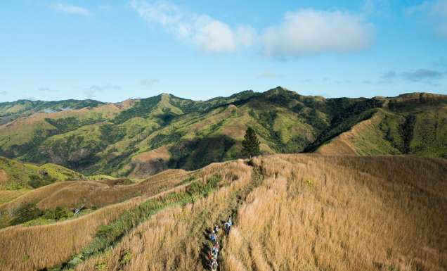 Hiking group through Fiji Highlands via a drone