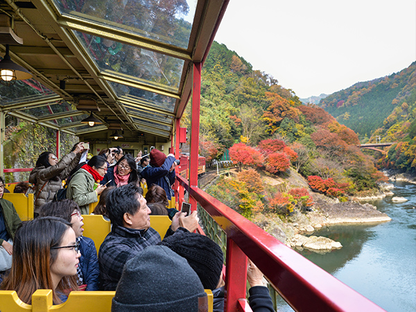 guests on Sagano Romantic Train in japan