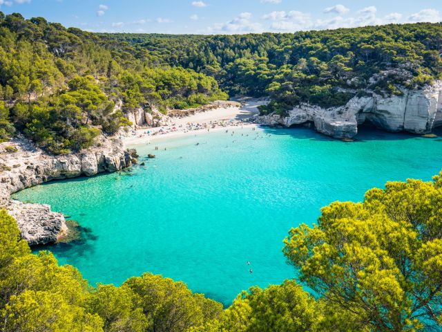 Cala Mitjana beach in Menorca .