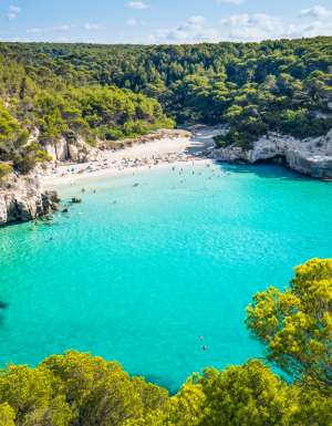 Cala Mitjana beach in Menorca .