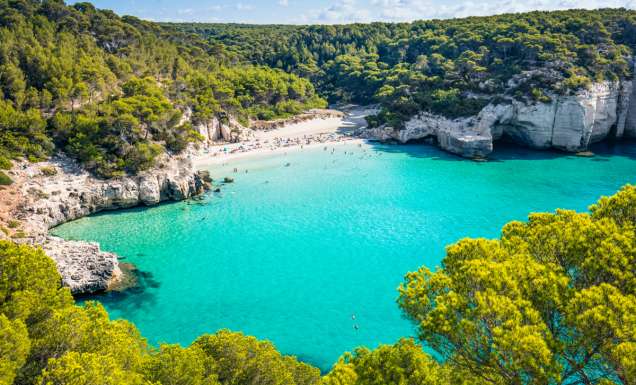 Cala Mitjana beach in Menorca .