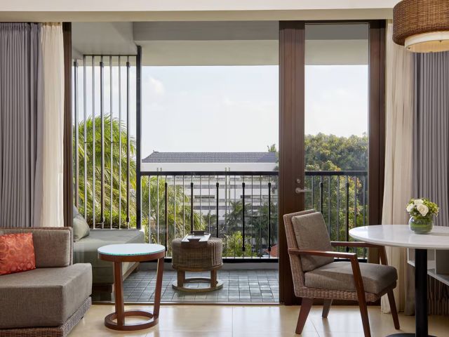 a suite with a balcony at Courtyard by Marriott Bali Seminyak Resort