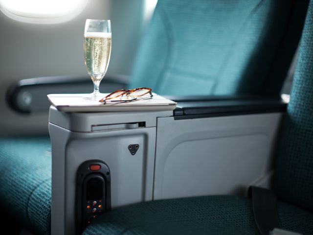 a complimentary glass of champagne onboard Cathay Pacific's Premium Economy