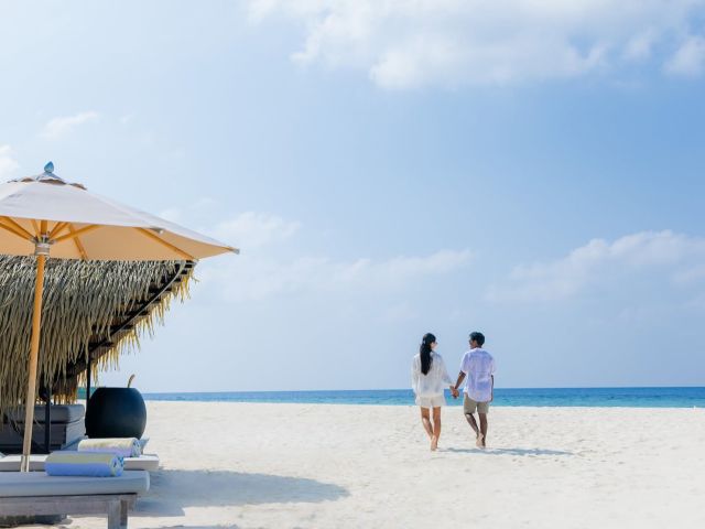 a couple walking hand in hand at Kudadoo Maldives Private Island