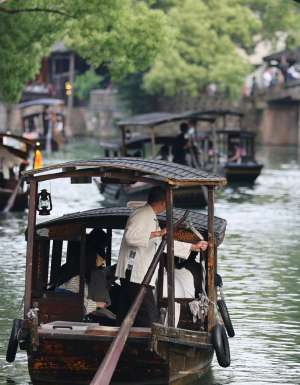 boats gliding past ancient canals in Zhujiajiao