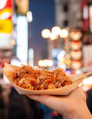person holding takoyaki in osaka