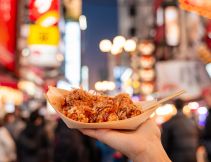 person holding takoyaki in osaka