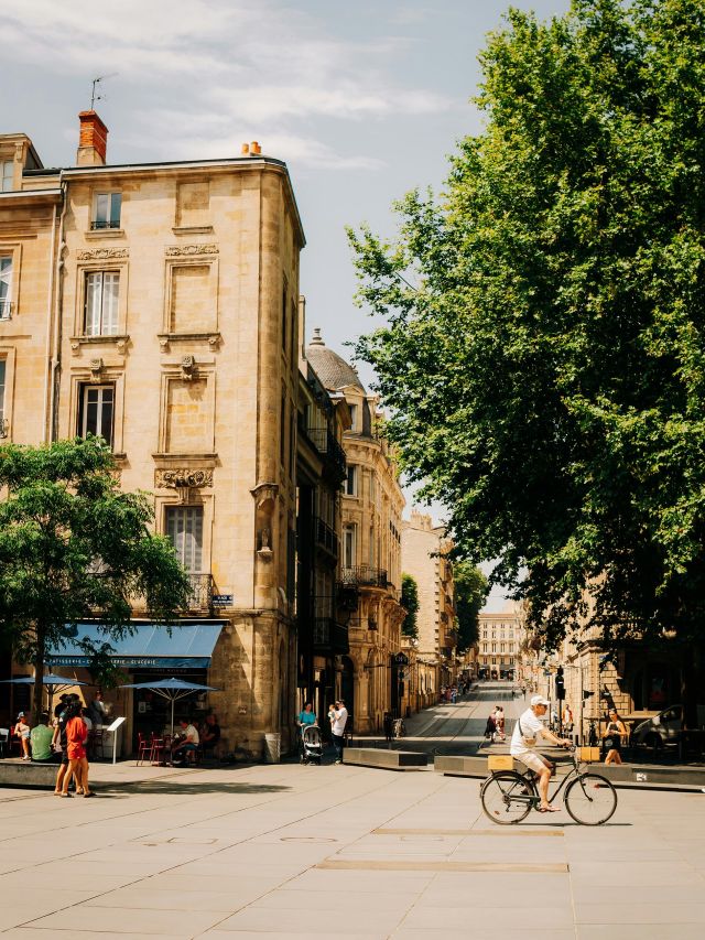 man rides his bike through the streets of france