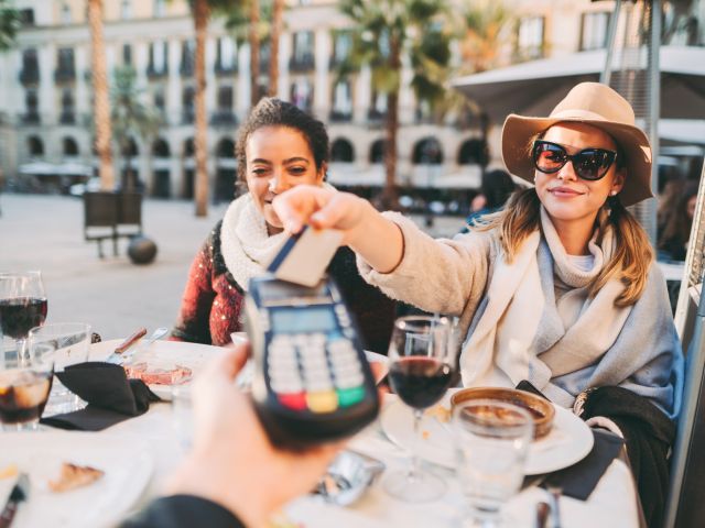 women in Barcelona paying contactless with credit card