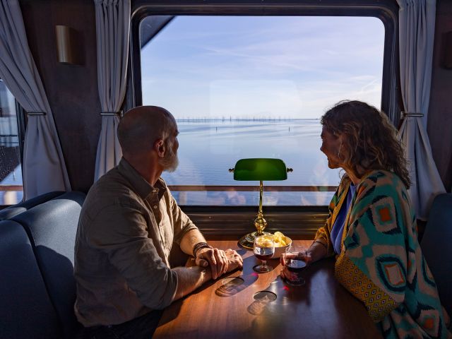 couple on Snälltåget train looking out the window