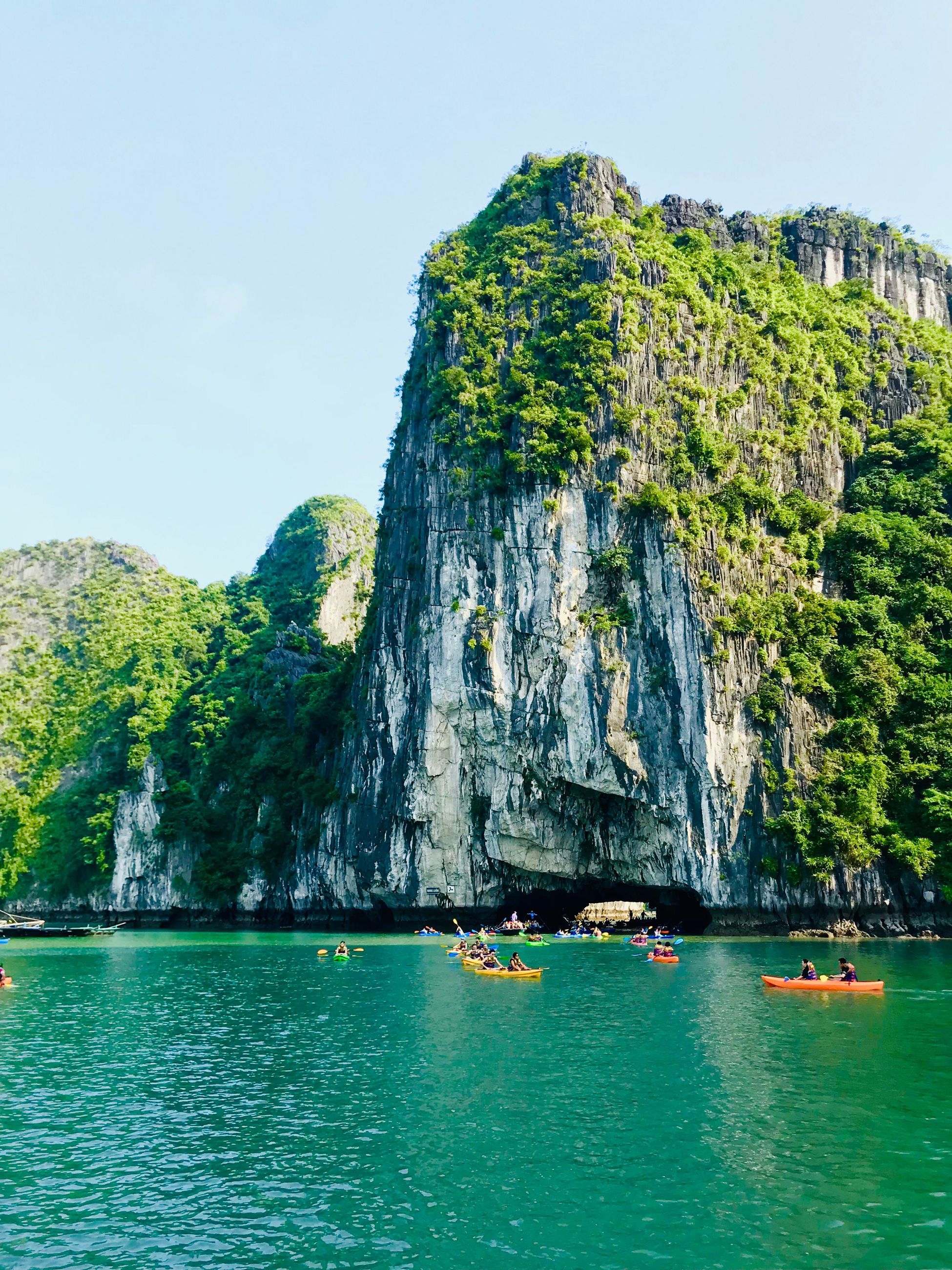 kayaking along scenic cliffs of Hạ Long Bay, Vietnam